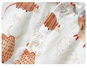 Macro detail of soft cotton baby romper fabric with cute animal prints and buttons