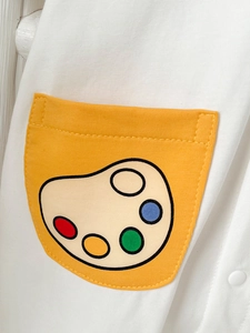 Short sleeve baby cotton romper featuring a white knit fabric with a yellow palette pocket