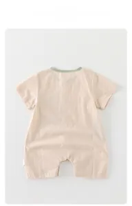 Detail view of baby short sleeve romper with breathable fabric and soft green collar trim