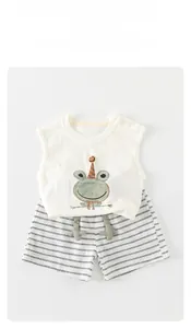 Detailed shot of baby summer outfit with 3D frog pattern on white sleeveless vest