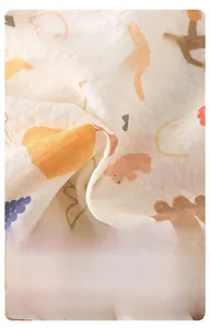Detailed macro view of soft breathable muslin cotton fabric with cute cartoon prints