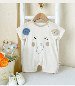 Detail view of baby cotton romper with cartoon elephant print and 3D ears on a wooden hanger