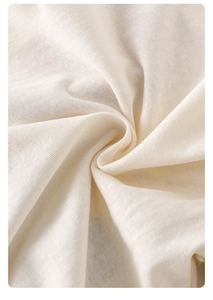 Close-up of soft cream knit fabric texture on breathable cotton baby romper