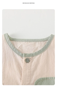 Close-up of baby romper neckline featuring breathable pink cotton and green button