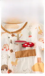 Close-up of baby short sleeve romper showing breathable cotton fabric and mushroom embroidery