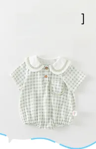 Detail of baby summer romper featuring light green gingham check and Peter Pan collar