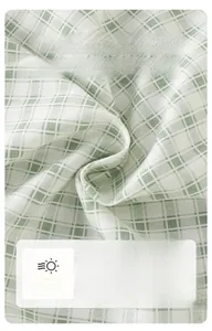 Close-up of soft green plaid cotton fabric with breathable texture for baby clothing