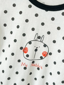 Short sleeve baby bodysuit with black polka dots and a cute cartoon rabbit print