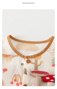 Detail of baby cotton gauze bodysuit featuring mushroom embroidery and wood buttons