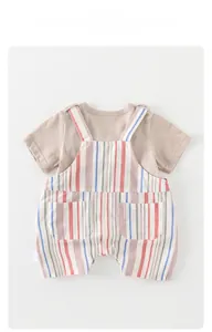 Detail of baby summer set showing striped cotton-linen overalls and soft T-shirt texture