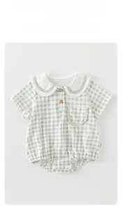 Detail of baby plaid romper showing Peter Pan collar and wood buttons on cotton fabric