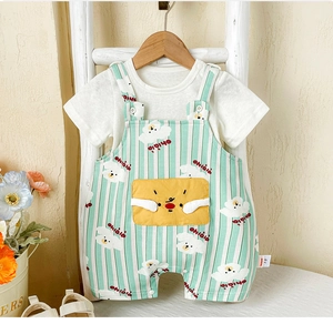 Detail of baby summer set showing green striped overalls with cute yellow cartoon pocket