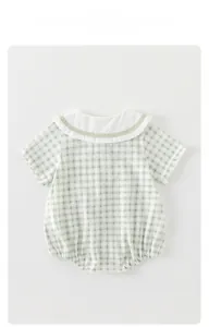 Close-up of the baby romper white Peter Pan collar and green checkered pattern
