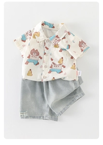 Detailed close-up of baby boy summer shirt with bear prints and denim shorts set
