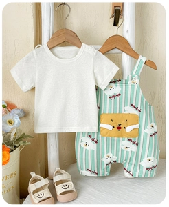 Detail of baby summer set with white t-shirt and green striped cartoon bib shorts