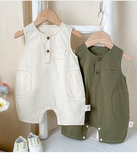 Detail of baby cotton linen sleeveless romper with wood buttons and chest pocket