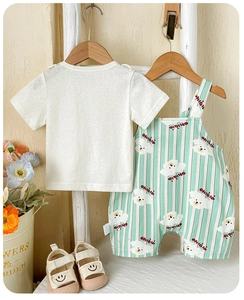 Detail of baby summer set featuring white T-shirt and green striped bear overalls