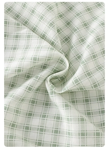 Detailed macro shot of light green checkered cotton fabric for baby summer rompers