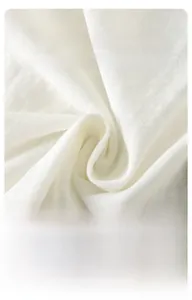 Close-up of soft white breathable cotton knit fabric texture for baby romper