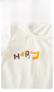 Detail of baby white short sleeve t-shirt showing elastic ribbed collar and HAPPY print