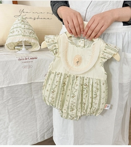 Detail of baby floral cotton romper set with lace collar and matching sun hat