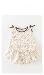 Detail of floral baby girl set featuring tie-shoulder sleeveless top and bloomers