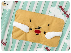 Detail of green striped baby outfit with yellow cartoon patch and fine cotton texture