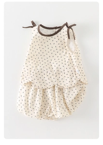 Flat lay of baby girl sleeveless floral top and bloomers set with bow tie shoulders