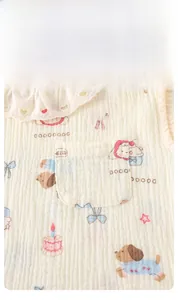 Detail of baby cotton gauze top featuring lace ruffled collar and cute puppy print