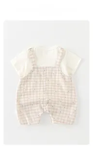 Detail of baby summer set with plaid pattern overalls and cute mini bear prints