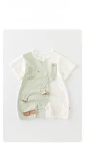 Detail of baby onesie with green elephant patchwork design and snap buttons