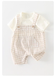 Close-up of baby romper with bear pattern, wooden buttons and cotton fabric detail
