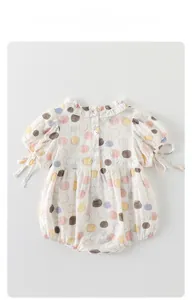 Detail of baby cotton seersucker romper with colorful polka dots and ruffled collar
