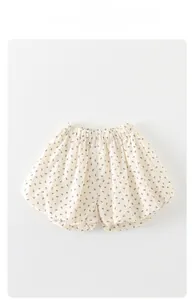 Detail of baby floral bloomers showing elastic waistband and black bow pattern