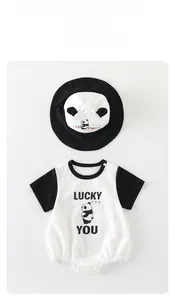 Flat lay of cotton baby bodysuit and matching sun hat with cute panda print and lucky you text