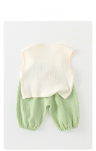 Close-up of breathable cotton gauze fabric on sleeveless baby summer vest and shorts set