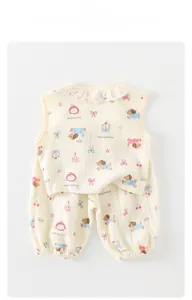 Detailed macro view of cotton gauze toddler outfit featuring puppy prints and embroidery