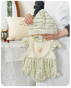 Detailed shot of baby cotton floral romper set with matching sun hat and ruffle collar