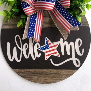 Patriotic wooden Welcome sign with American flag bow and faux greenery for door decor