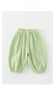 Detail view of light green breathable cotton gauze baby bloomers with elastic waist and cuffs