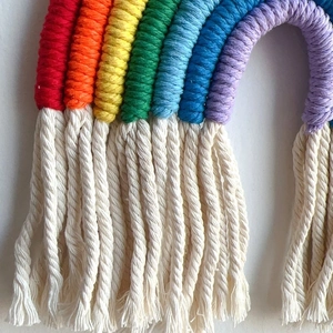 Handmade rainbow woven wall hanging with cotton tassels for nursery and bedroom decor