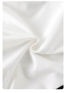 Close-up of soft white cotton baby bodysuit fabric showing delicate fiber texture