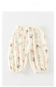 Detail of baby cotton pants with puppy and cupcake prints and elastic waist and cuffs