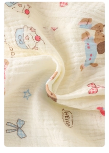 Macro shot of breathable cotton gauze fabric with cute teddy bear and cupcake patterns