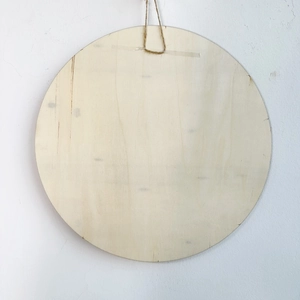 Macro detail of natural round wooden welcome plaque with rustic jute rope for hanging