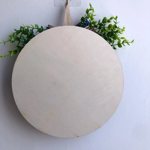 Round wooden blank sign with faux greenery and burlap rope for DIY wall decor