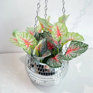 Close-up of hanging disco ball planter with realistic caladium leaves and metal chains