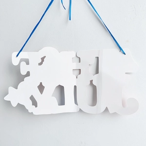 Detail of white 4th of July hanging plaque with laser-cut stars and blue ribbon hanger