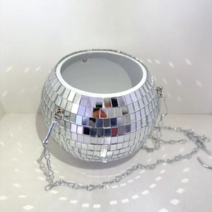 Close-up of disco ball hanging planter with silver mirror tiles and metal chain
