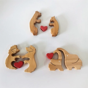 Set of wooden animal figurines with red heart accents including bears and elephants